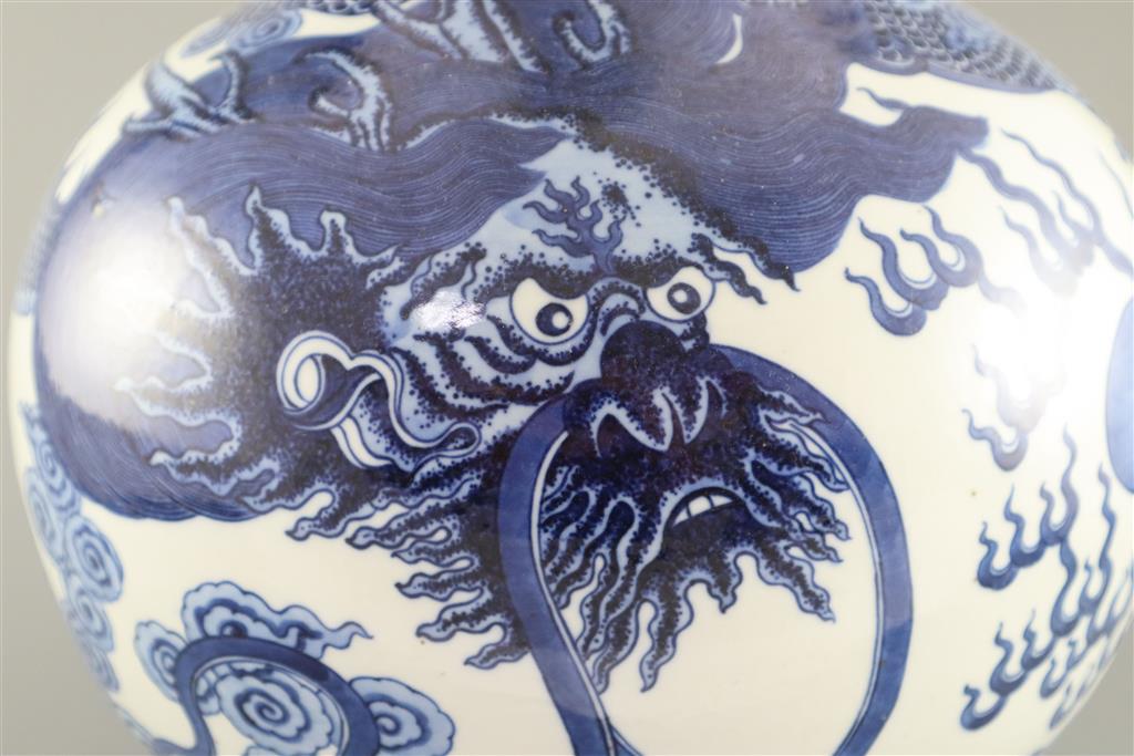 A large Chinese dragon bottle vase, Qianlong seal mark, probably late 19th century, 47cm high, wood stand
